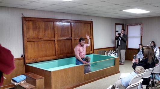 Elisabeth Conley being baptized by Elder Philip Conley