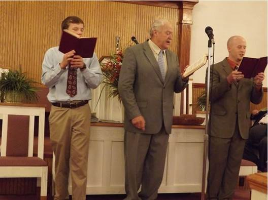Brothers Jacob Davidson, Donnie Howell, and Caleb Howell leading singing